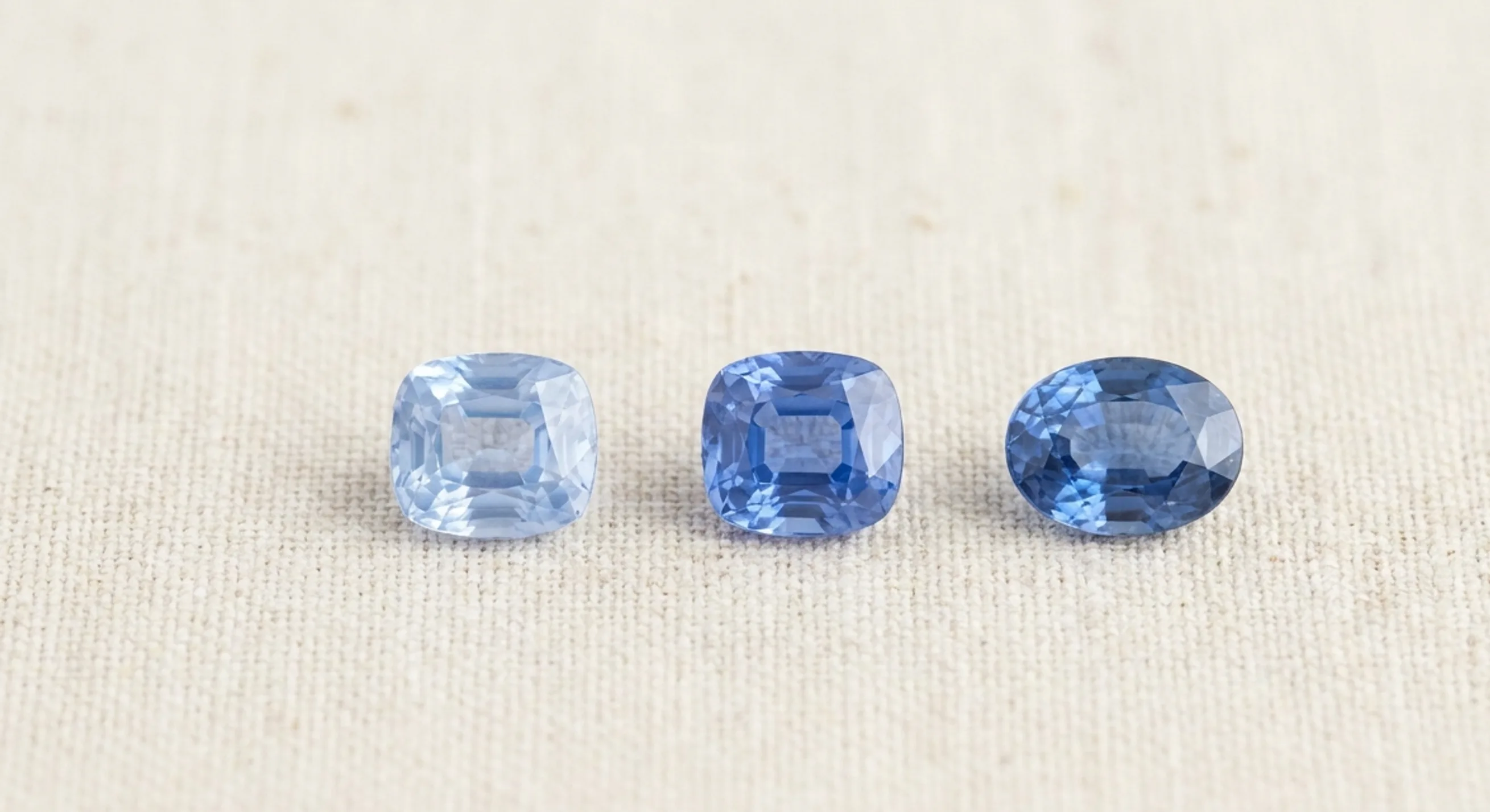 Three blue sapphires in a row, from light cornflower to medium-dark blue