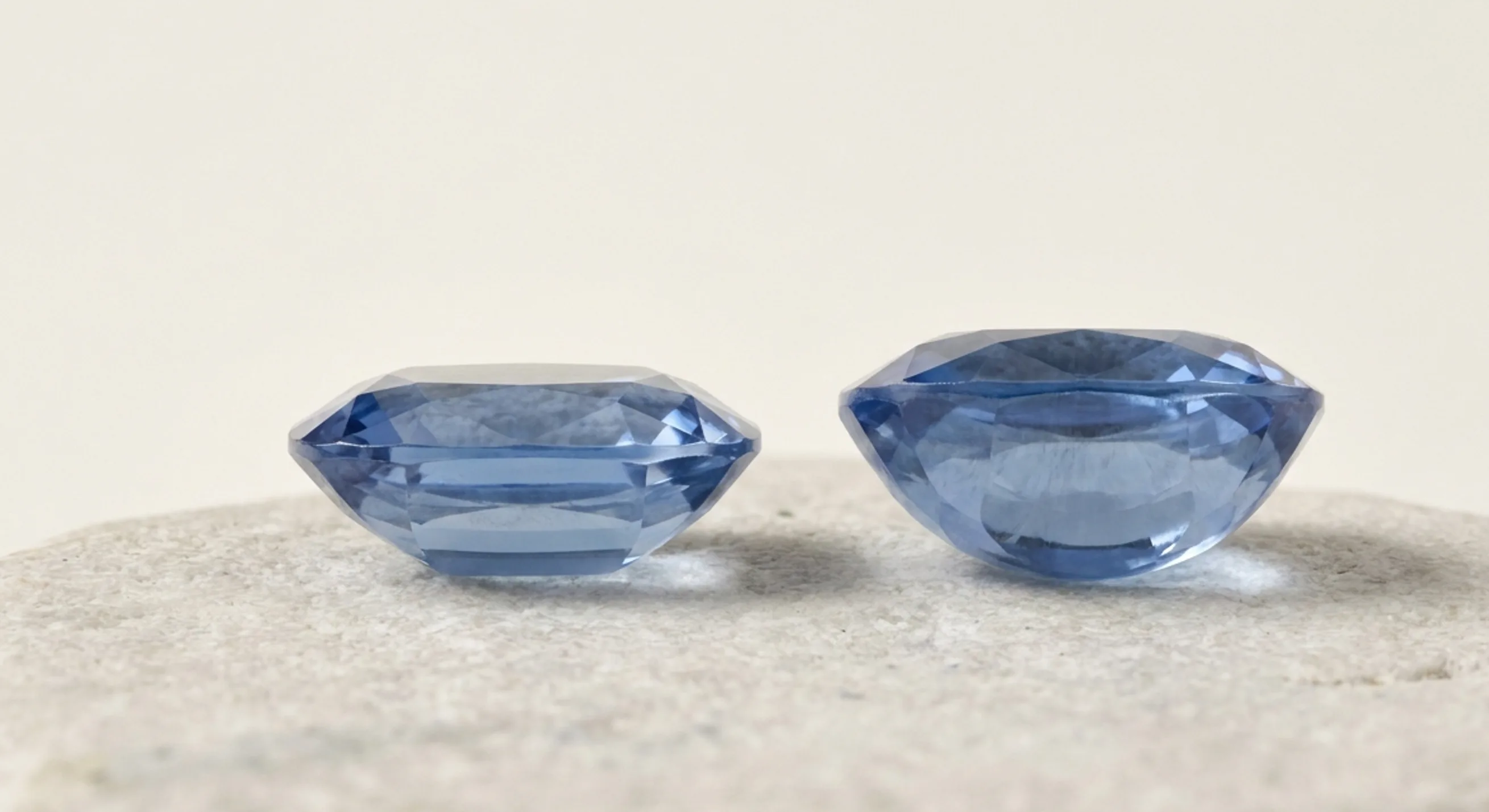 Side profiles of a well-proportioned blue sapphire and a deep native-cut sapphire with a heavy belly
